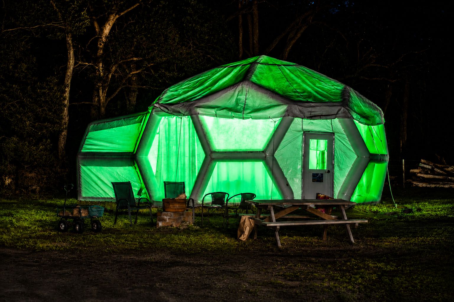 A geodesic dome glowing at night
