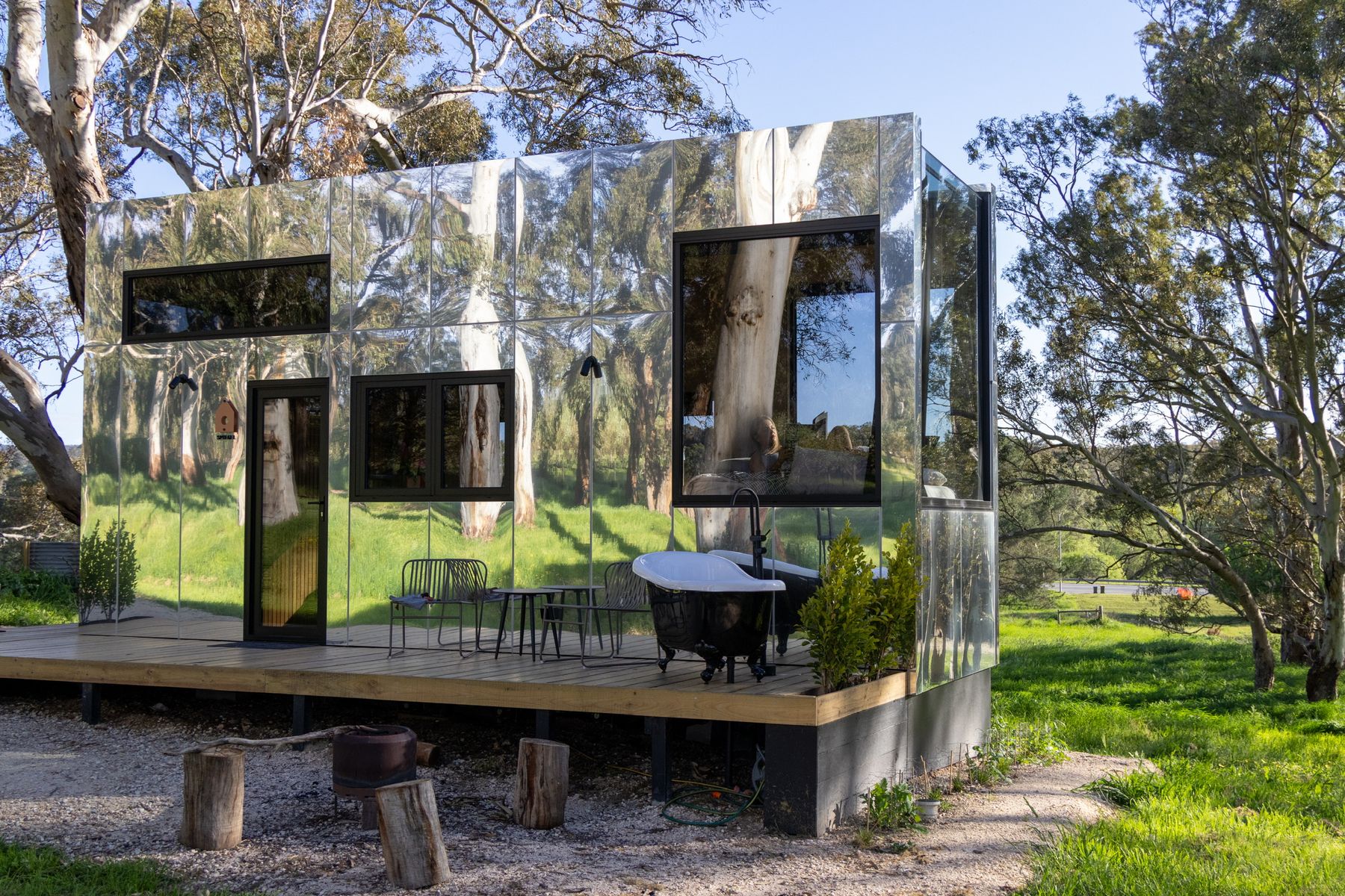 A mirror-clad cabin reflecting the bush
